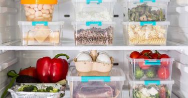 A picture of a well-organized refrigerator with compartments labeled with categories such as fruits, vegetables, lean proteins, and whole grains, with text overlay "How to Organize Your Fridge for a Healthier Diet: Tips and Tricks to Keep Your Food Fresh and Accessible