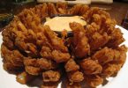 Outback Steakhouse Bloomin Onion: A large onion cut to look like a flower, deep-fried to perfection and served with a spicy bloom sauce, perfect as an appetizer or a side dish