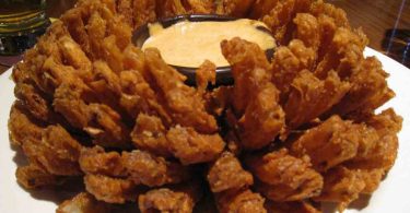 Outback Steakhouse Bloomin Onion: A large onion cut to look like a flower, deep-fried to perfection and served with a spicy bloom sauce, perfect as an appetizer or a side dish