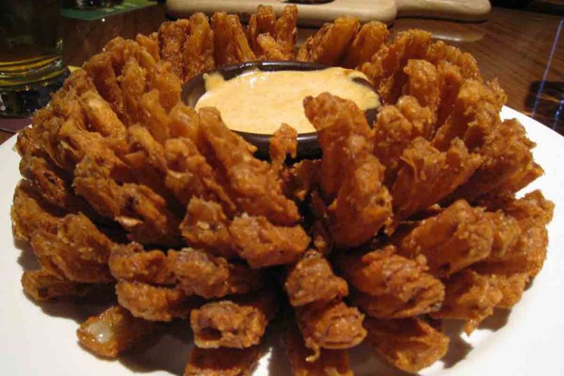 Outback Steakhouse Bloomin Onion: A large onion cut to look like a flower, deep-fried to perfection and served with a spicy bloom sauce, perfect as an appetizer or a side dish